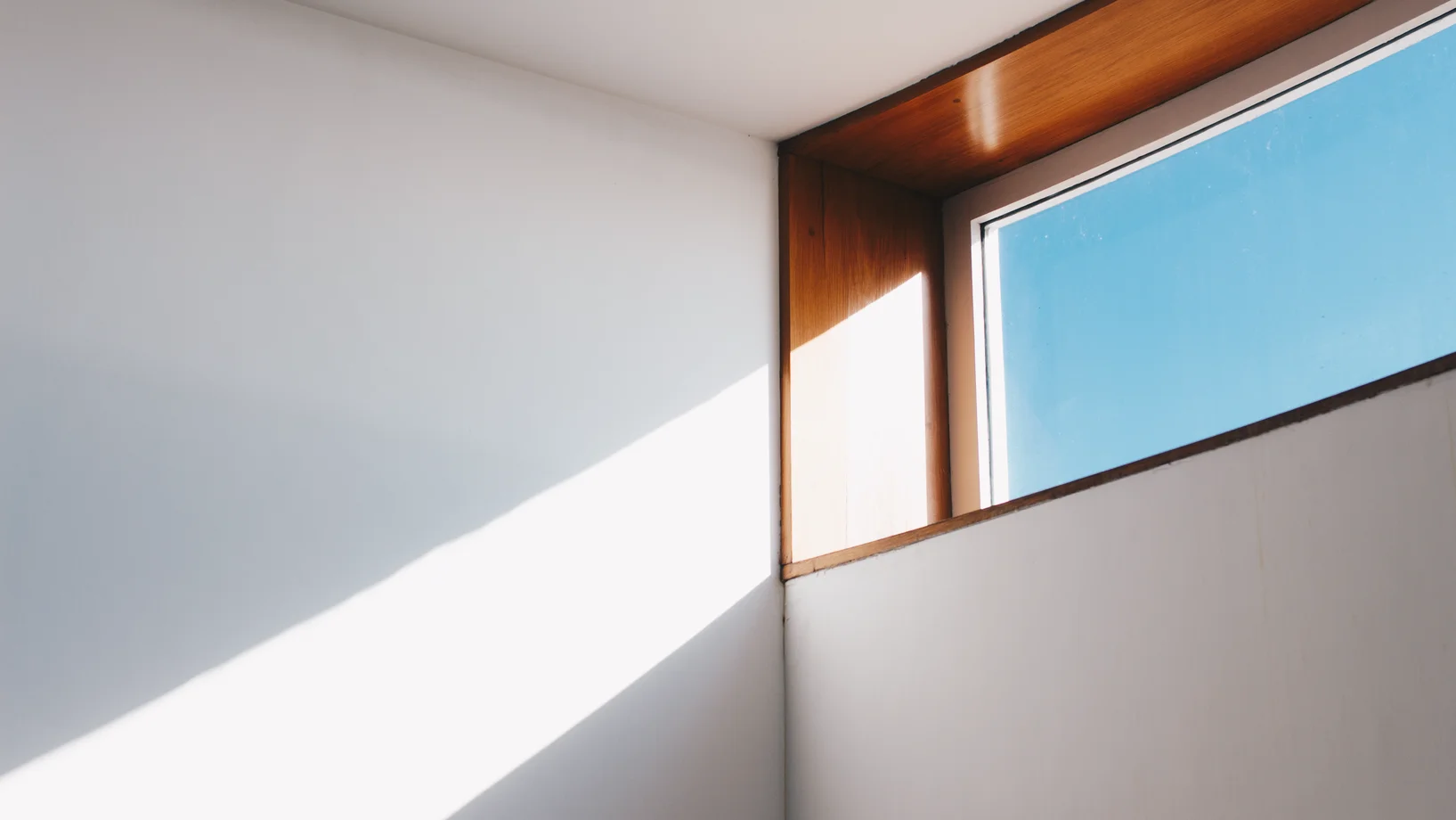 Clear glass window with brown and white wooden frame